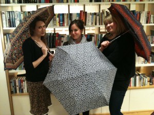 Members of the Orbit Books tema posing with parasols to promote the author Gail Carriger's UK tour (author of TIMELESS from The Parasol Protectorate series)